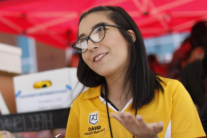 A student smiling while looking up at someone.